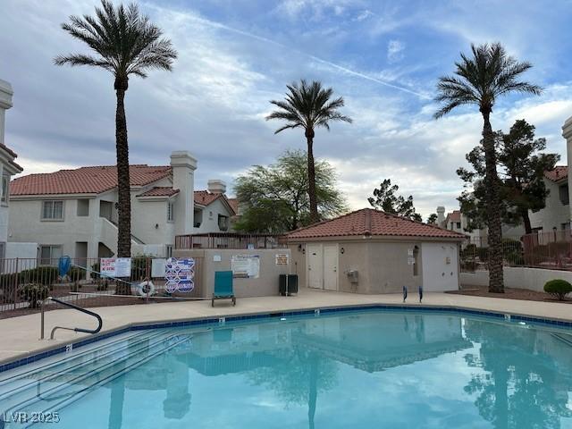 7900 Fossil Creek Ln Unit 103, Las Vegas, NV 89145 - pool featuring fence, a patio, and a residential view