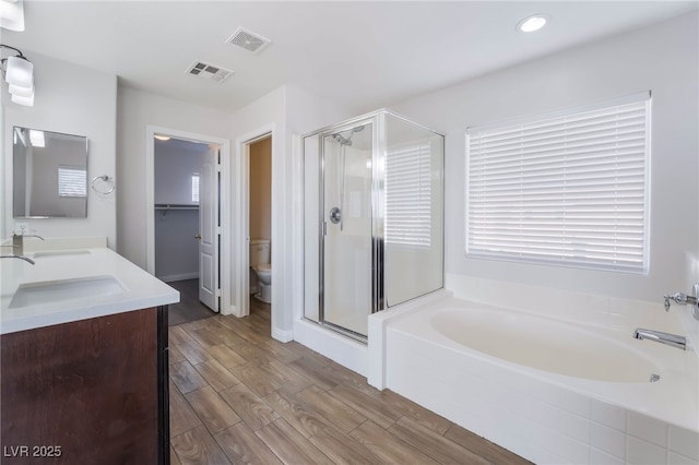 5940 Tamarack Lodge Ln, North Las Vegas, NV 89081 - full bathroom with a shower stall, visible vents, toilet, and a garden tub