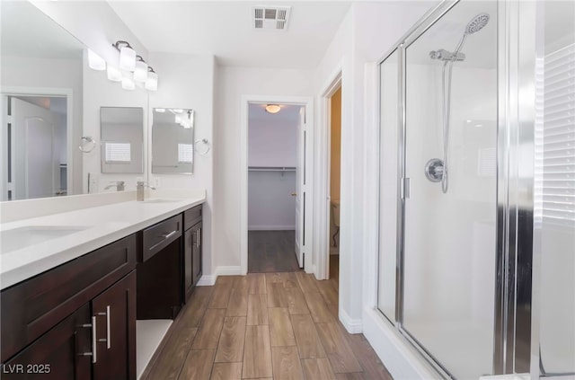 5940 Tamarack Lodge Ln, North Las Vegas, NV 89081 - full bath with a shower stall, wood finished floors, visible vents, and a sink