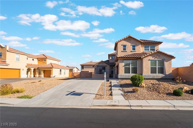 5940 Tamarack Lodge Ln, North Las Vegas, NV 89081 - mediterranean / spanish-style house with concrete driveway, a tiled roof, fence, stucco siding, and a residential view