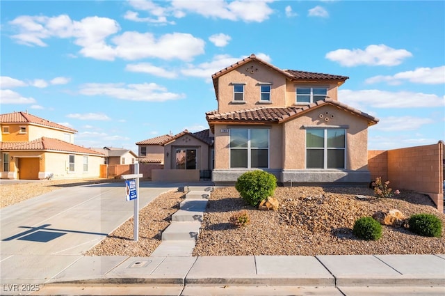 5940 Tamarack Lodge Ln, North Las Vegas, NV 89081 - mediterranean / spanish-style house featuring stucco siding, a tile roof, fence, and a residential view