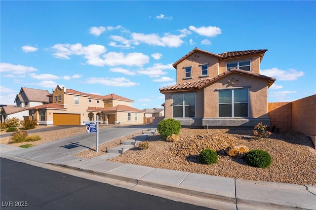 5940 Tamarack Lodge Ln, North Las Vegas, NV 89081 - mediterranean / spanish-style house with a residential view, a tiled roof, stucco siding, and fence