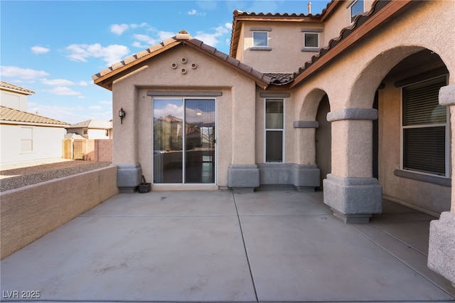 5940 Tamarack Lodge Ln, North Las Vegas, NV 89081 - rear view of property with stucco siding, a tiled roof, fence, and a patio