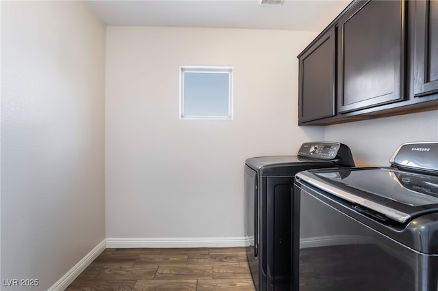5940 Tamarack Lodge Ln, North Las Vegas, NV 89081 - laundry area with cabinet space, dark wood finished floors, visible vents, and washing machine and clothes dryer