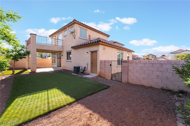 5940 Tamarack Lodge Ln, North Las Vegas, NV 89081 - back of property with a gate, stucco siding, a fenced backyard, and a balcony