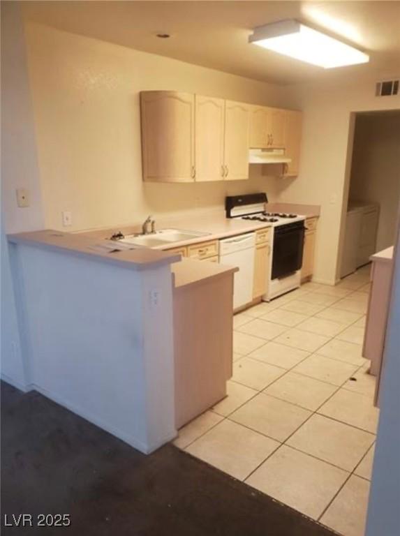 7709 Bauble Ave, Las Vegas, NV 89128 - kitchen featuring light tile patterned floors, white appliances, a peninsula, visible vents, and a sink