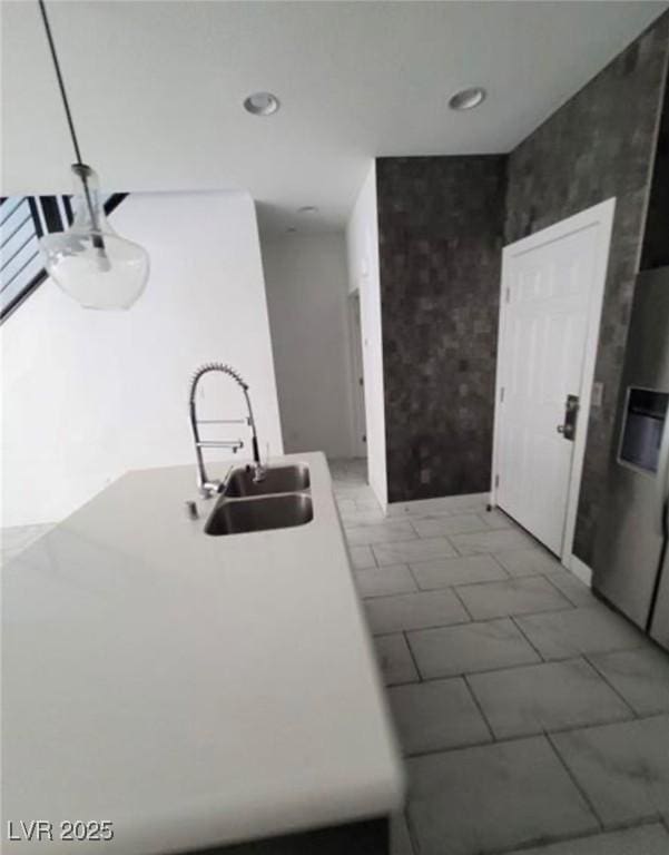 kitchen featuring a sink and stainless steel fridge