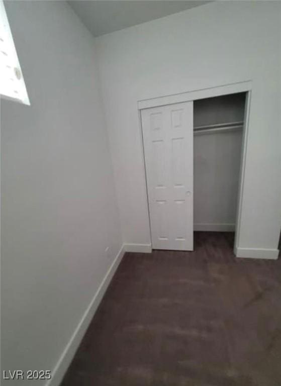 unfurnished bedroom featuring a closet and baseboards