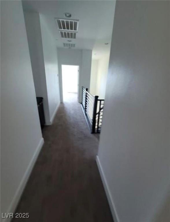 hallway featuring an upstairs landing, visible vents, and baseboards