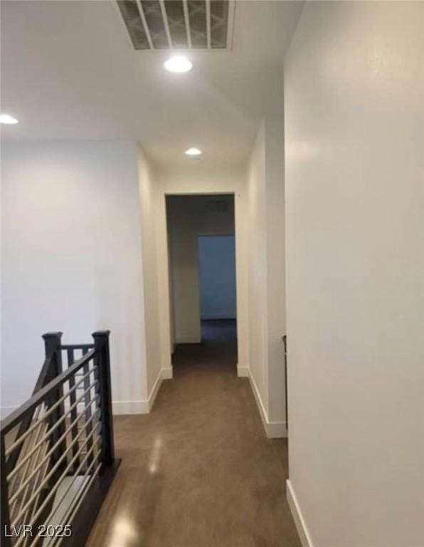 corridor with recessed lighting, visible vents, and baseboards