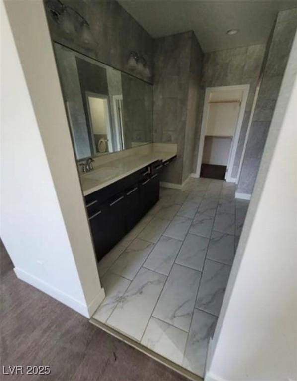 bathroom featuring vanity, marble finish floor, and baseboards