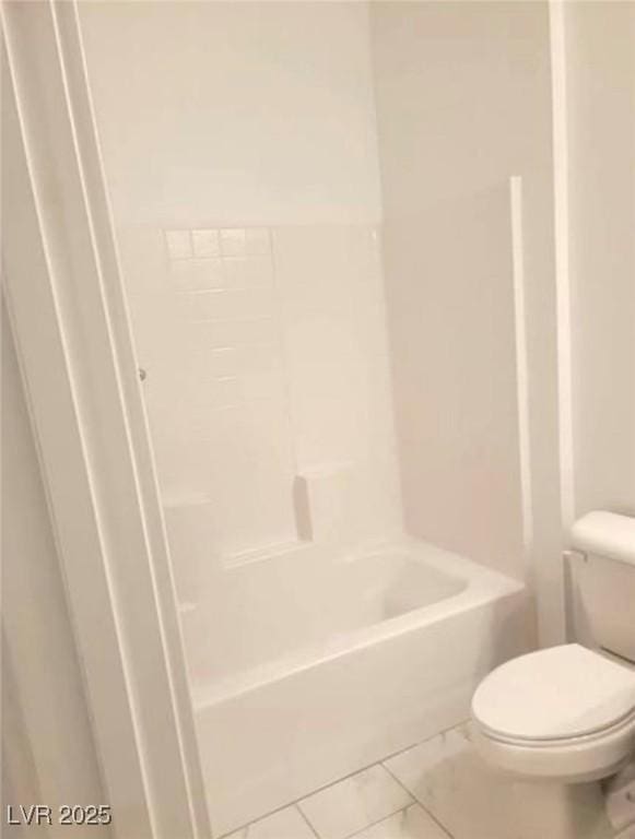 full bathroom featuring marble finish floor and toilet