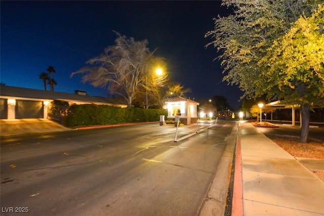 view of road with sidewalks and curbs