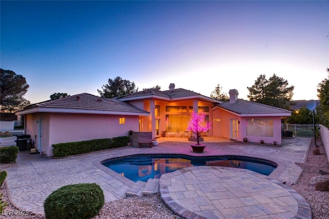 view of swimming pool featuring fence, a fenced in pool, and a patio