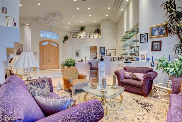 living room with recessed lighting and a towering ceiling