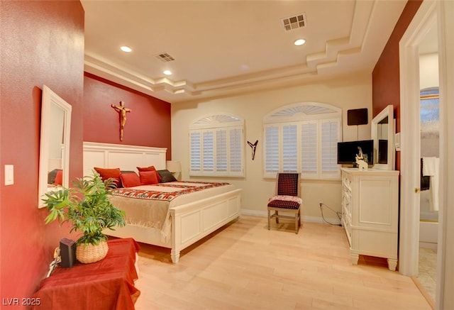 bedroom featuring recessed lighting, a tray ceiling, visible vents, and light wood-style flooring