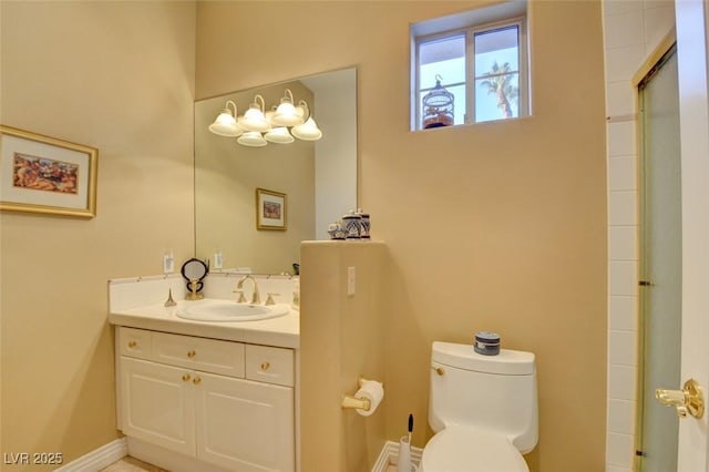 full bathroom featuring vanity, a shower with door, and toilet