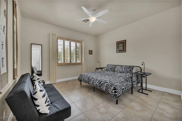 bedroom featuring light tile patterned floors, baseboards, and a ceiling fan