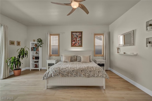 bedroom with light wood finished floors, baseboards, and a ceiling fan