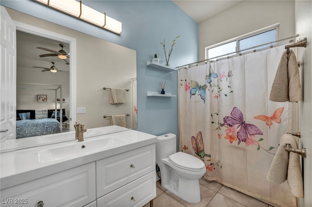 ensuite bathroom featuring ensuite bathroom, toilet, ceiling fan, vanity, and tile patterned flooring