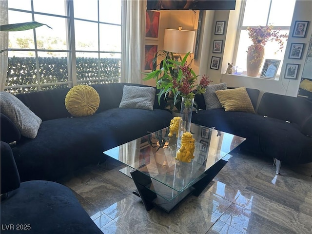 living area featuring marble finish floor