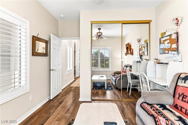 interior space with ceiling fan, baseboards, and wood finished floors