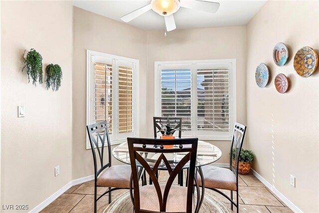 dining area with light tile patterned floors, baseboards, and ceiling fan