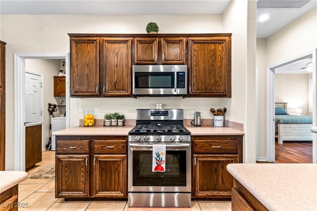 kitchen featuring light tile patterned floors, appliances with stainless steel finishes, and light countertops