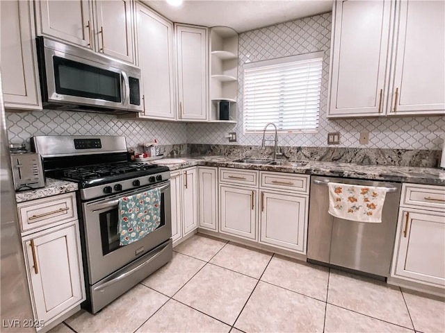 kitchen featuring a sink, light tile patterned floors, tasteful backsplash, and stainless steel appliances
