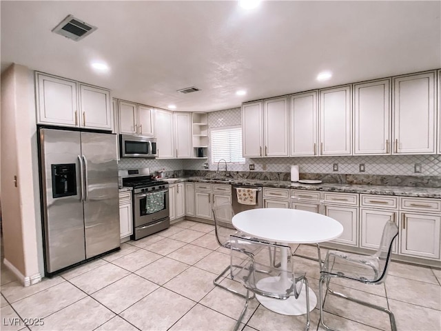 kitchen featuring a sink, visible vents, appliances with stainless steel finishes, and open shelves