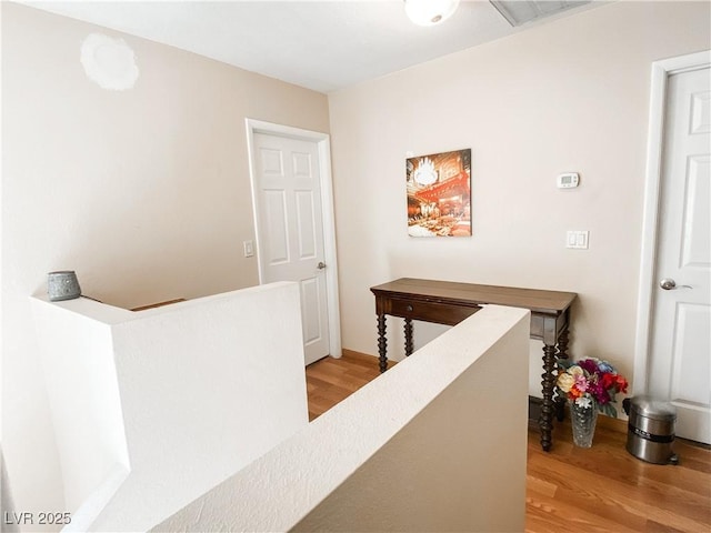 hallway featuring visible vents and light wood-style flooring