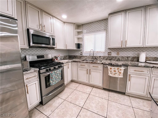kitchen featuring open shelves, light tile patterned flooring, dark stone counters, and stainless steel appliances
