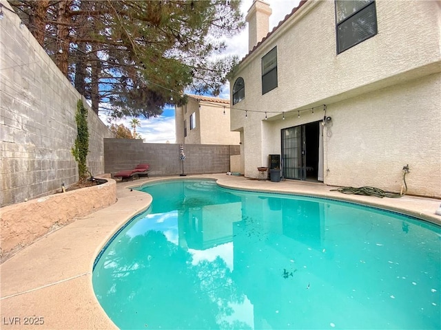 view of swimming pool featuring a fenced backyard and a fenced in pool