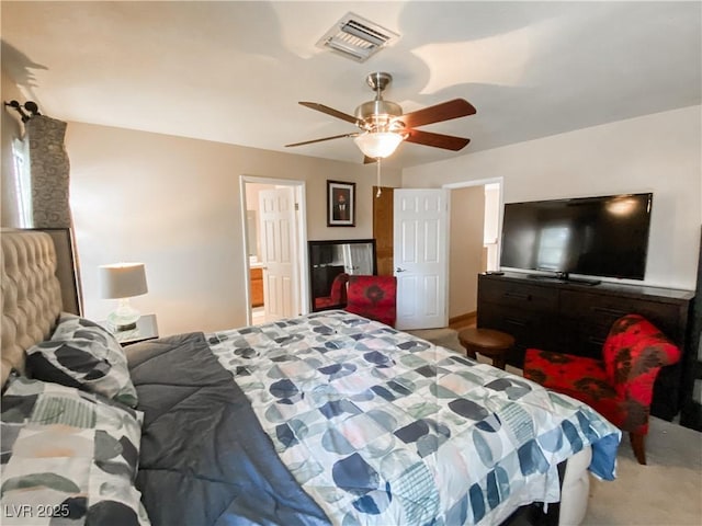 carpeted bedroom featuring a ceiling fan and visible vents