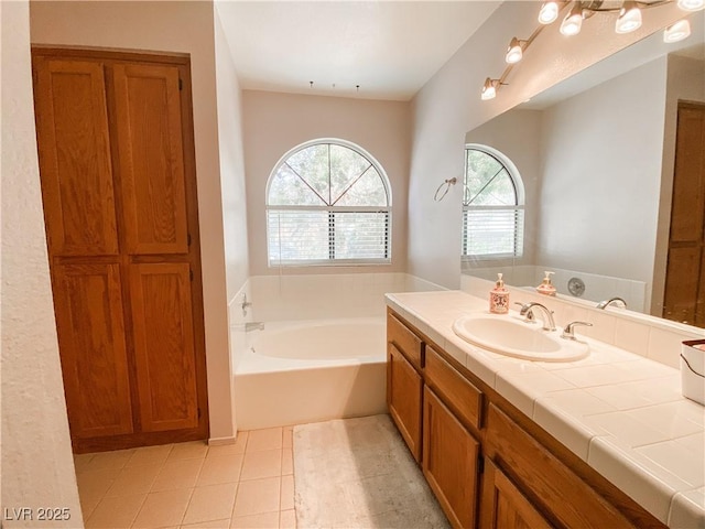 full bathroom with tile patterned floors, vanity, and a garden tub