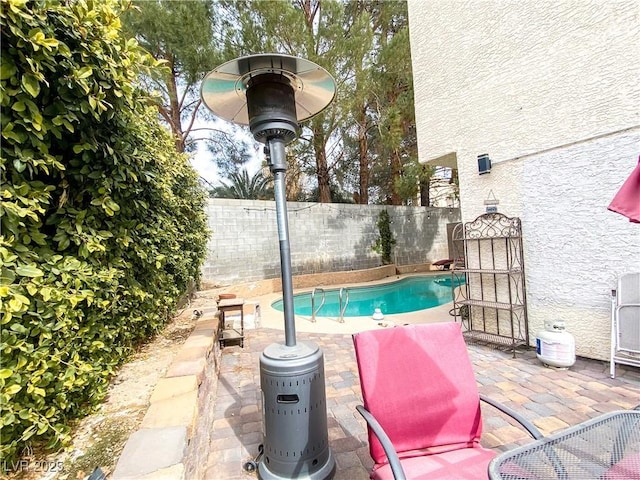 view of swimming pool featuring a patio, a fenced backyard, and a fenced in pool