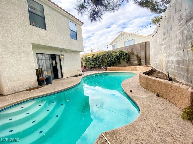 view of pool with a fenced in pool, a patio, and a fenced backyard