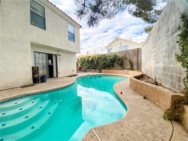 view of swimming pool featuring a fenced in pool, a patio, and a fenced backyard
