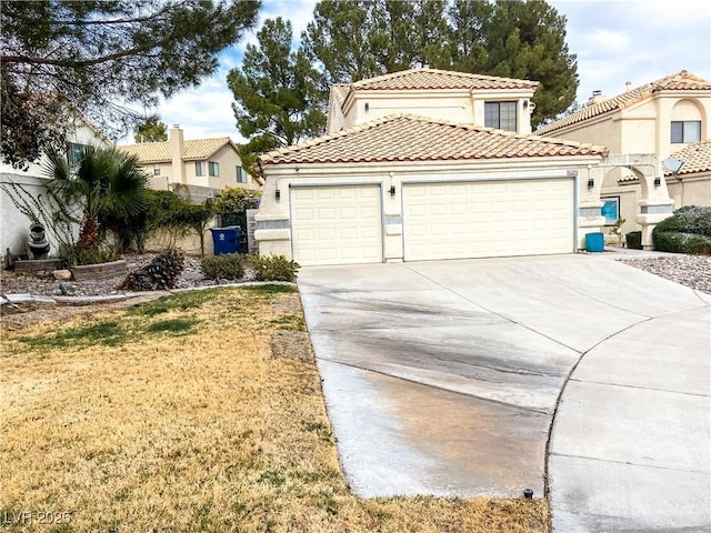 view of front facade with an attached garage, a tiled roof, driveway, and stucco siding