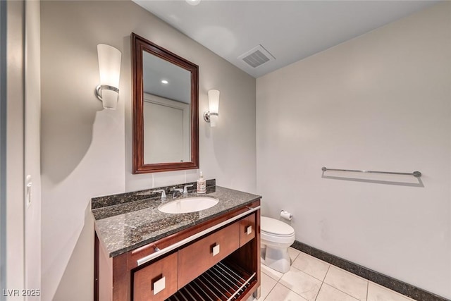 bathroom featuring vanity, toilet, tile patterned floors, baseboards, and visible vents