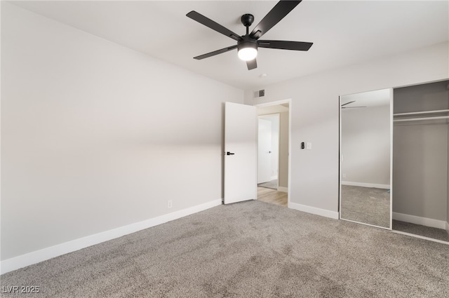 unfurnished bedroom with a closet, a ceiling fan, visible vents, carpet flooring, and baseboards