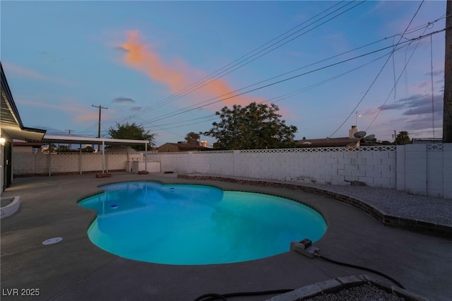 pool at dusk featuring a fenced in pool, a patio area, and a fenced backyard