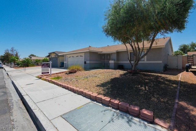 6361 W Viking Rd, Las Vegas, NV 89103 - ranch-style home featuring stucco siding, an attached garage, a gate, and driveway