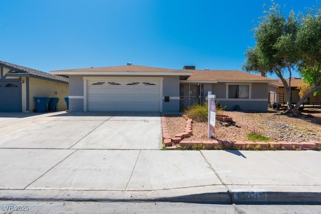 ranch-style home with an attached garage, concrete driveway, and stucco siding