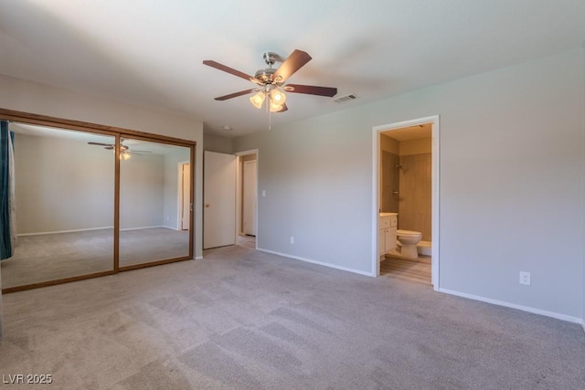 unfurnished bedroom with light colored carpet, baseboards, a closet, and visible vents