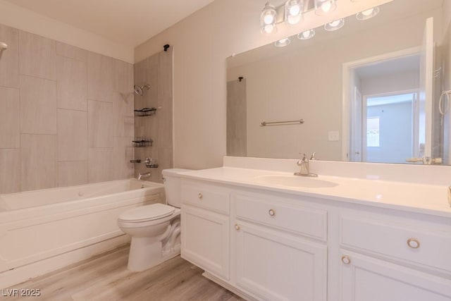 bathroom featuring toilet, bathing tub / shower combination, vanity, and wood finished floors