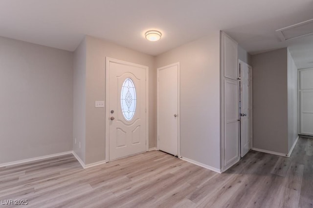 foyer featuring baseboards and light wood-style flooring