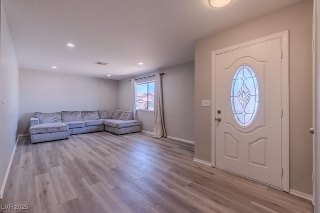 entrance foyer featuring wood finished floors, baseboards, and recessed lighting