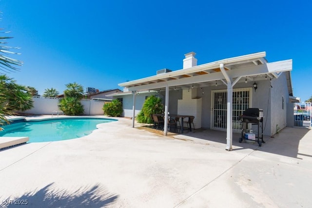 view of pool with grilling area, fence, a patio, and a fenced in pool