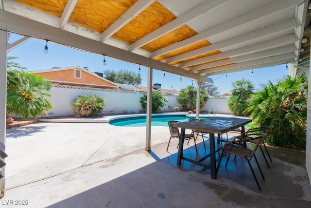 view of pool with outdoor dining area, a patio, a fenced backyard, and a fenced in pool